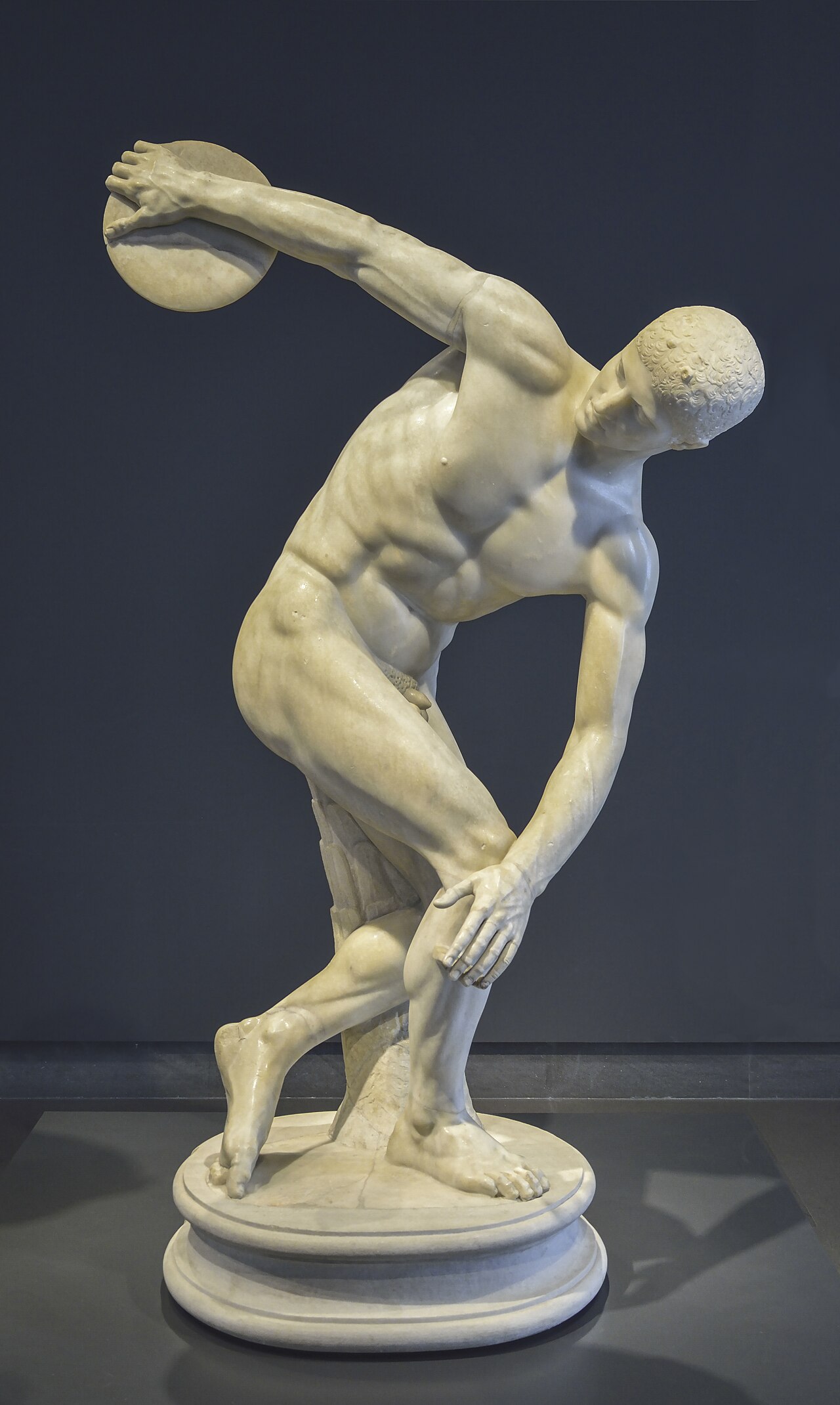 Classical statue of a discus thrower preparing to release the discus